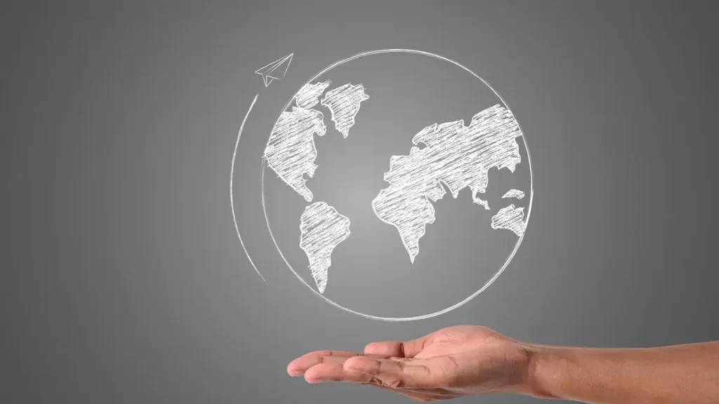 Comunica&ccedil;&atilde;o internacional. Mundo desenhado na palma da m&atilde;o de um homem branco.